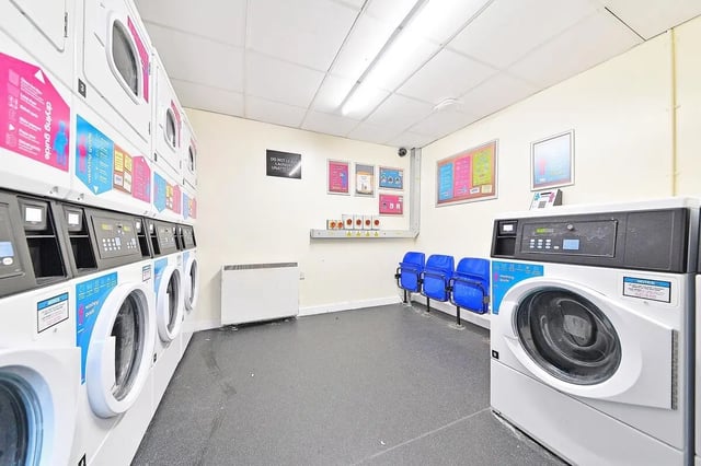 Washing machines drying racks and seating laundry room at Canalside in Birmingham Student Accommodation