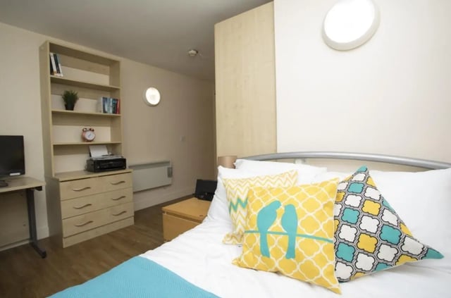 Bed desk printer pillows and bookshelf bedroom at Daisybank Villas in Manchester Student Accommodation