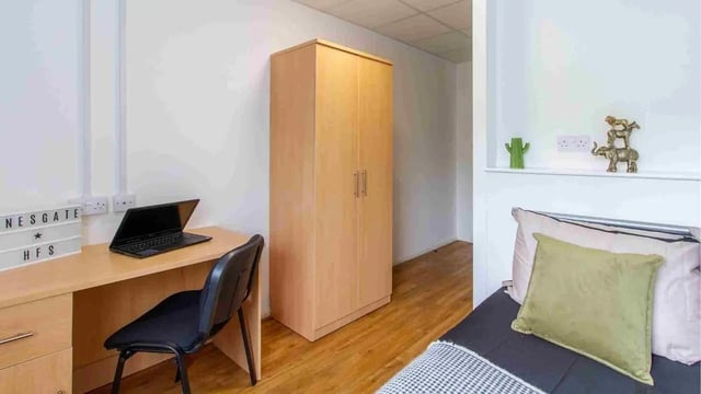 Desk laptop chair wardrobe and bed bedroom at Danesgate House in Lincoln Student Accommodation