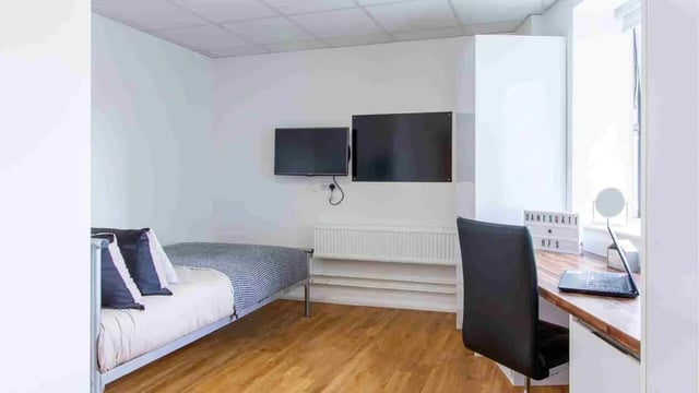 Bed desk two televisions study area bedroom at Danesgate House in Lincoln Student Accommodation