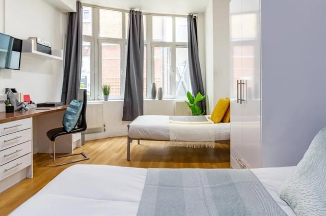 Two beds desk chair and wardrobe bedroom at Portobello Garrow House in London Student Accommodation