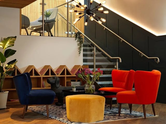 Chairs dog ottoman plants living room at Heald Court in Manchester Student Accommodation
