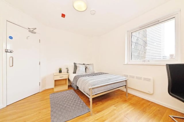 Bed nightstand rug and door bedroom at Manchester Court in Manchester Student Accommodation