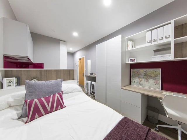 Bed desk kitchen area and white cabinets Bedroom at AXO Kingston in Kingston Upon Thames Student Accommodation