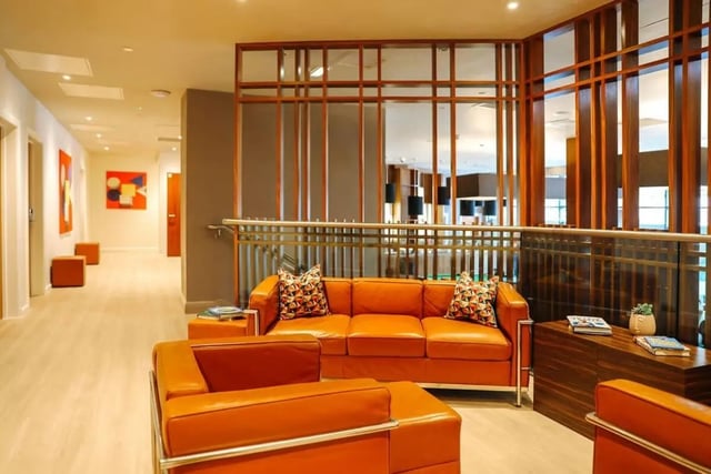 Orange couches hallway artwork lounge area at St. Andrew Street in Aberdeen Student Accommodation