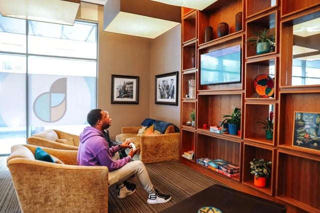 Men playing video games in lounge area at St. Andrew Street in Aberdeen Student Accommodation