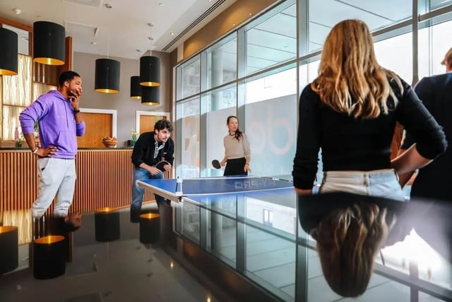 People playing ping pong in a communal lounge area at St. Andrew Street in Aberdeen Student Accommodation