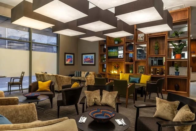 Lounge seating with bookshelf and television Living room at St. Andrew Street in Aberdeen Student Accommodation