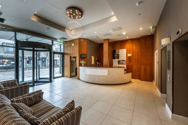 Reception area with sofas and revolving doors lobby at St. Andrew Street in Aberdeen Student Accommodation