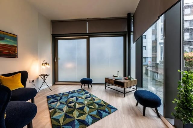 Sofa rug coffee table and stools living room at St. Andrew Street in Aberdeen Student Accommodation