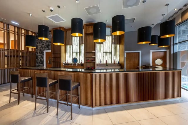 Bar with stools and pendant lights communal area at St. Andrew Street in Aberdeen Student Accommodation