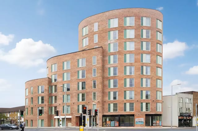 Curved brick building with many windows exterior at Orbital in Nottingham Student Accommodation