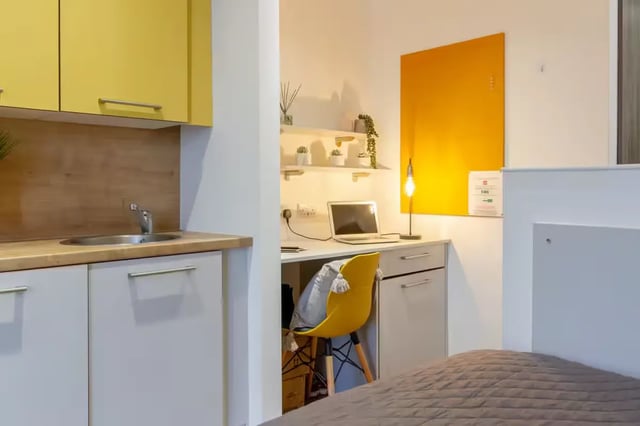 Kitchen desk laptop yellow chair study area at Orbital in Nottingham Student Accommodation