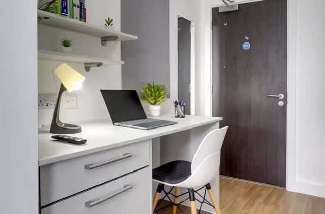 Desk with laptop lamp and chair study area at Orbital in Nottingham Student Accommodation