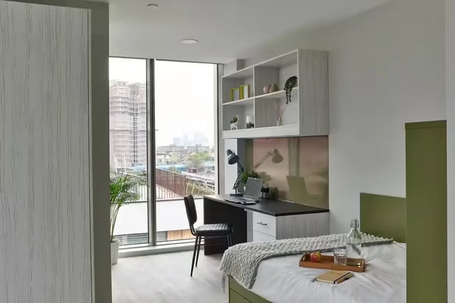 Bed with desk and shelves Student room at Flora Building - Hoxton in London Student Accommodation