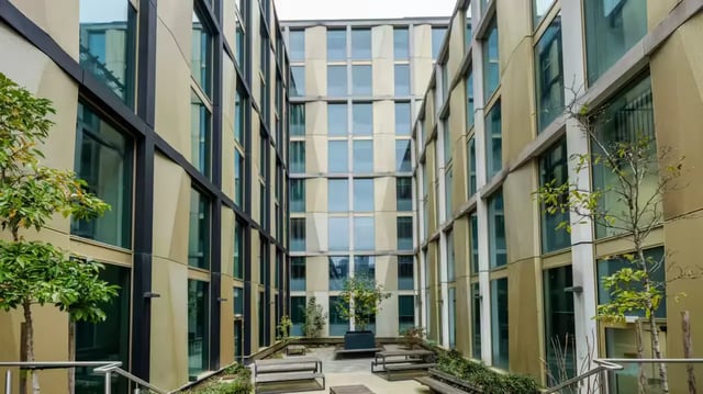 Courtyard with benches and trees exterior at Flora Building - Hoxton in London Student Accommodation