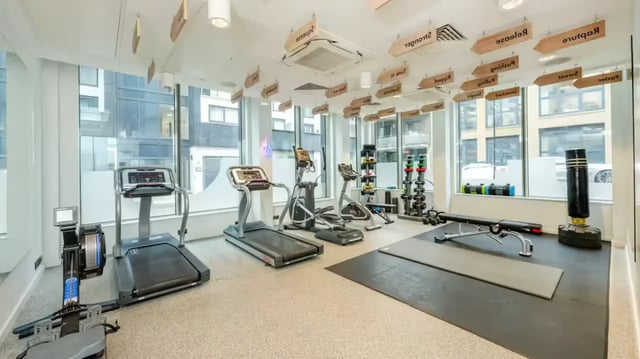 Treadmills elliptical rower weights punching bag gym area at Flora Building - Hoxton in London Student Accommodation