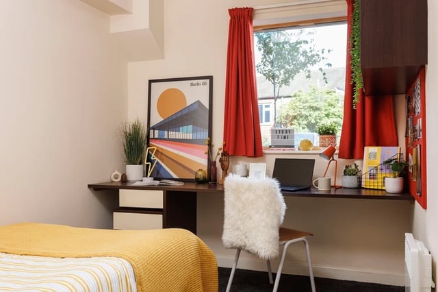 Desk with laptop and fluffy chair bedroom at Byron Central in Newcastle Upon Tyne Student Accommodation