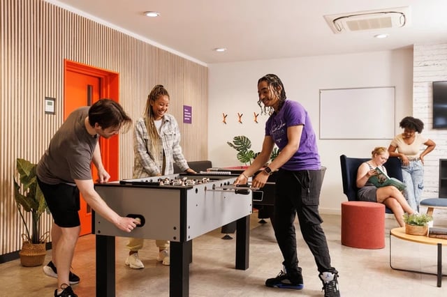 Students playing foosball and relaxing common room at Byron Central in Newcastle Upon Tyne Student Accommodation