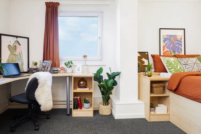 Desk chair plants books framed art bedroom study area at James Watt in Birmingham Student Accommodation