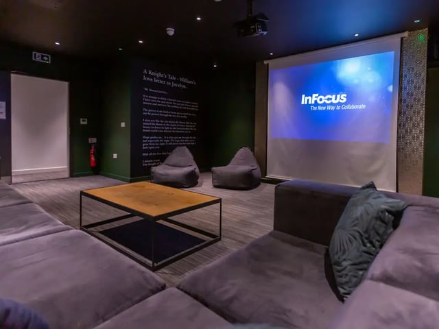 Lounge area with projector beanbags coffee table cinema room at Canterbury Student Manor in Canterbury Student Accommodation