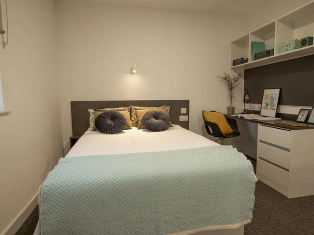 Bed desk chair and shelves bedroom at Canterbury Student Manor in Canterbury Student Accommodation