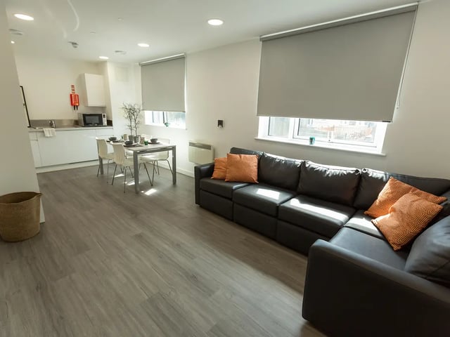 Sofa dining table kitchen and living room at Canterbury Student Manor in Canterbury Student Accommodation