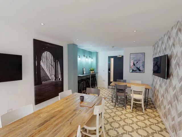 Dining area with large wooden table and chairs communal area at Canterbury Student Manor in Canterbury Student Accommodation
