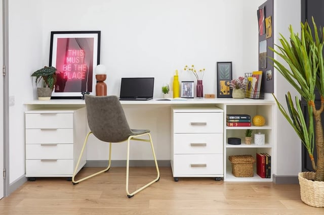 Desk with laptop chair plant and artwork Study area at Battery Park in Birmingham Student Accommodation