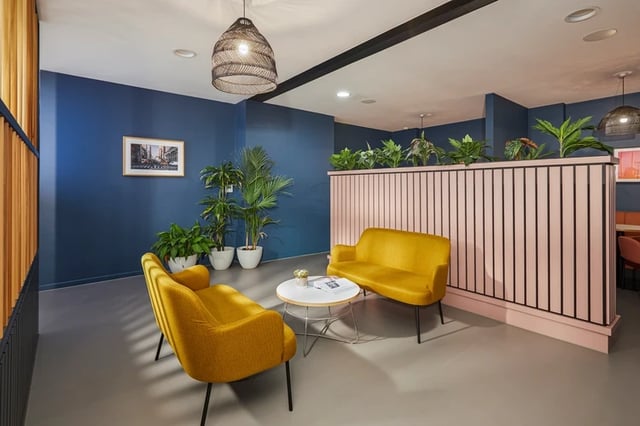 Yellow sofas plants picture living room at Battery Park in Birmingham Student Accommodation