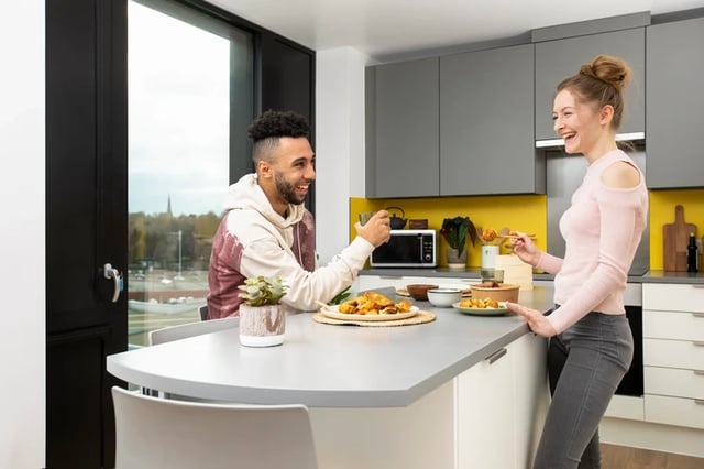 Couple eating at kitchen island kitchen at Battery Park in Birmingham Student Accommodation