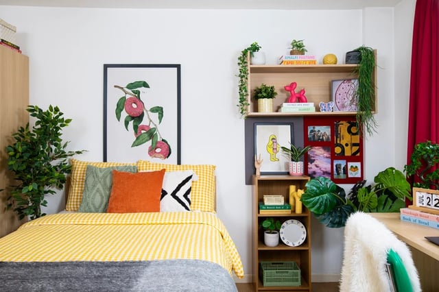 Bed with yellow covers and art artwork bedroom at Romano Court in London Student Accommodation