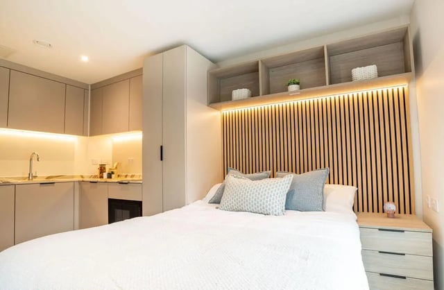 Bed with kitchen cabinets and storage bedroom at Yugo Rothesay House in Bournemouth Student Accommodation