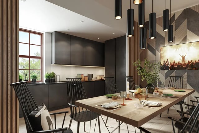 Modern dining kitchen with black cabinets and large table at Yugo Rothesay House in Bournemouth Student Accommodation