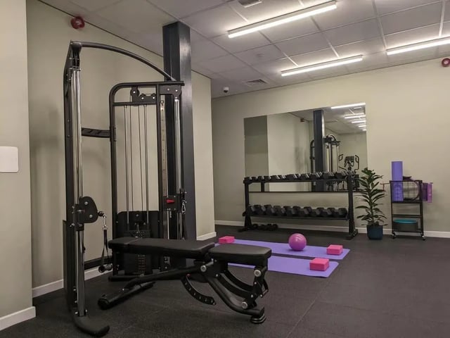 Gym equipment with weights yoga mats and ball fitness room at Parklands in Dundee Student Accommodation