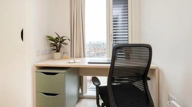 Desk with drawers laptop plant and chair study area at Parklands in Dundee Student Accommodation