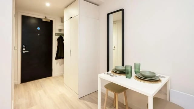 Wardrobe table with dishes and mirror study area at Parklands in Dundee Student Accommodation