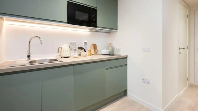 Modern kitchen with sage green cabinets sink microwave kitchen at Parklands in Dundee Student Accommodation