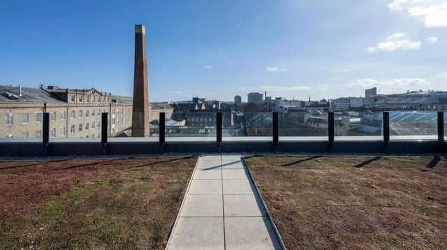 Green roof path with glass railing and city view exterior at Parklands in Dundee Student Accommodation