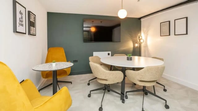 Round table chairs artwork TV common area at Clarence Dock Village in Leeds Student Accommodation