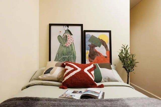 Bed with framed art pillows and plant Bedroom at Curzon House in Nottingham Student Accommodation