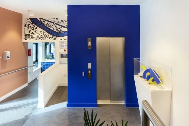 Modern elevator and map mural hallway at Hollis Wharf in Bath Student Accommodation