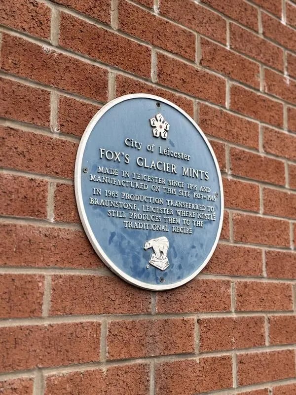Blue plaque on brick wall exterior at Mintworks in Leicester Student Accommodation