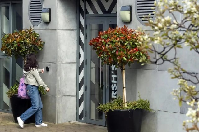 Woman uses access card at building entrance exterior at Copley Court in Cork Student Accommodation
