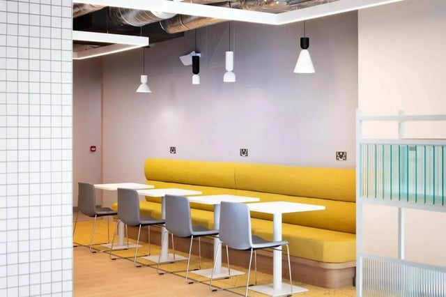 Yellow booth white tables grey chairs communal area at Coleman Court in Cork Student Accommodation