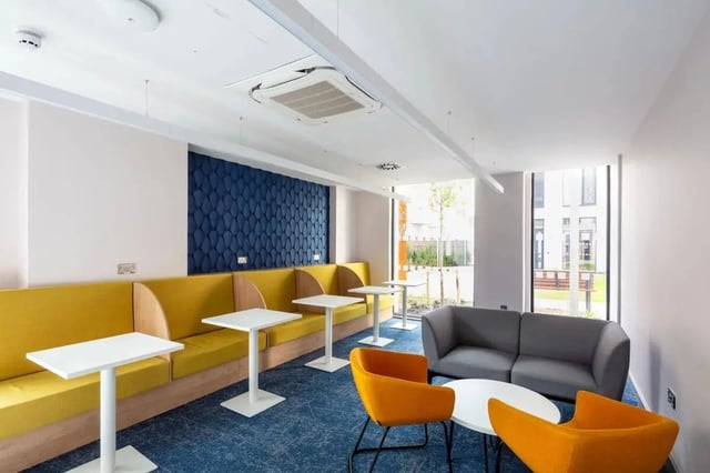 Yellow booths grey sofa orange chairs living room at Coleman Court in Cork Student Accommodation