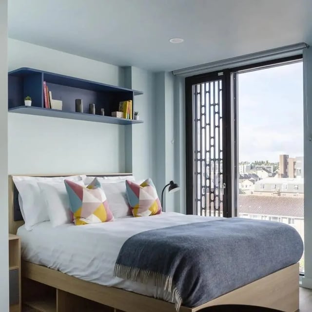Bed with pillows blanket and shelf Bedroom at Coleman Court in Cork Student Accommodation