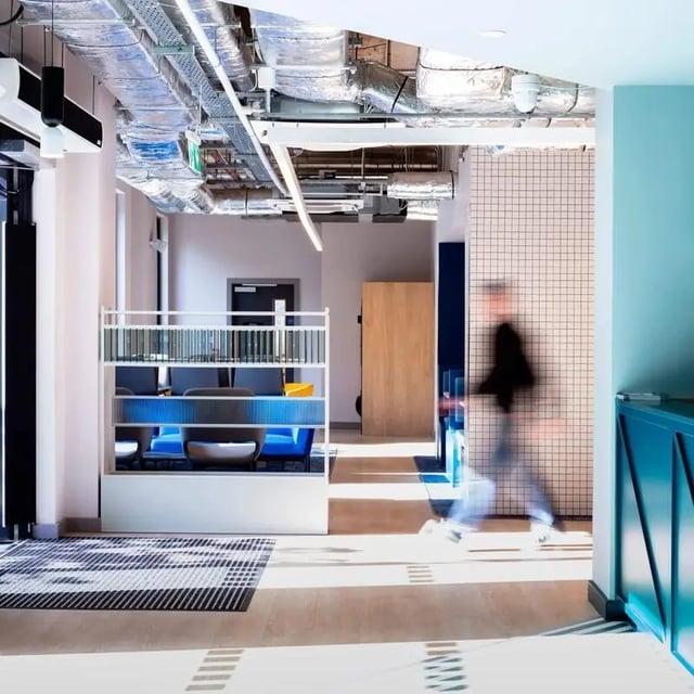 Desks with blue seating and shelving communal area at Coleman Court in Cork Student Accommodation