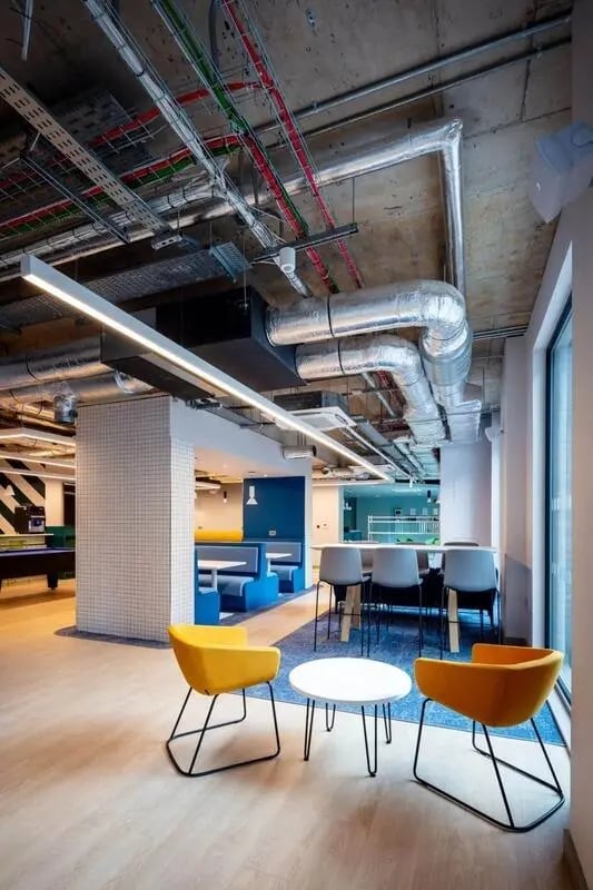 Yellow chairs white table blue seating area lounge at Coleman Court in Cork Student Accommodation