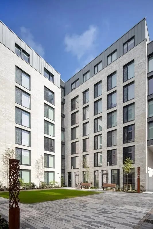 Modern buildings with courtyard garden and benches exterior at Coleman Court in Cork Student Accommodation